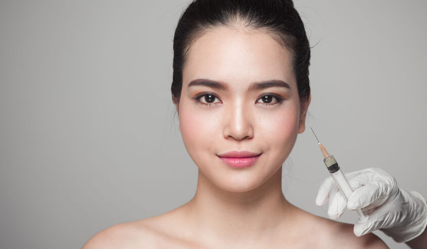 beautiful asian woman gets beauty facial injections. face aging injection.