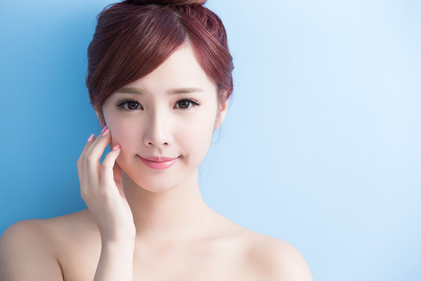beauty skin care woman smile to you isolated on bluebackground, asian